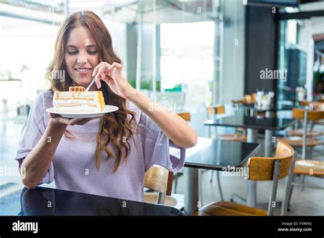 Pretty Brunette Enjoying A Cake Stock Photo Alamy