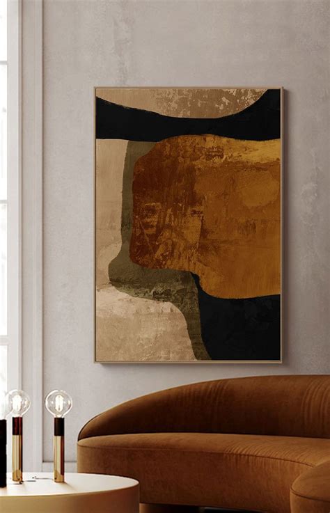 An Abstract Painting Hangs On The Wall Above A Couch In A Living Room