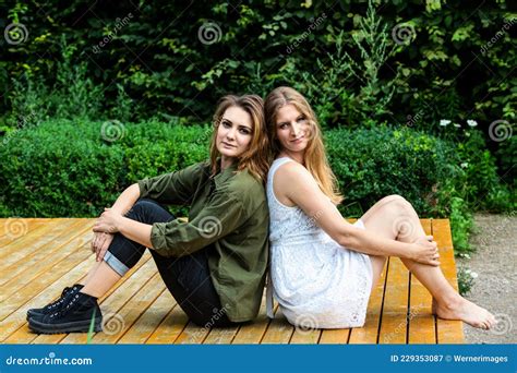 Portrait De Deux Jeunes Femmes Assis Sur Le Banc Du Parc Image Stock