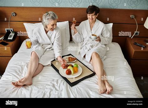 Senior Lesbian Couple Basking In Tender Love And Affection On A Cozy