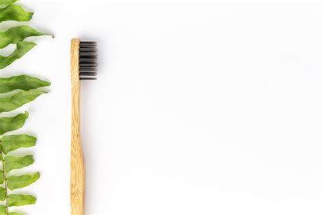 Premium Photo Bamboo Toothbrush On White Surface