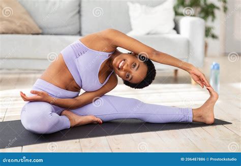 Happy Fit Black Lady Stretching Her Legs Doing Yoga Poses Or Pilates