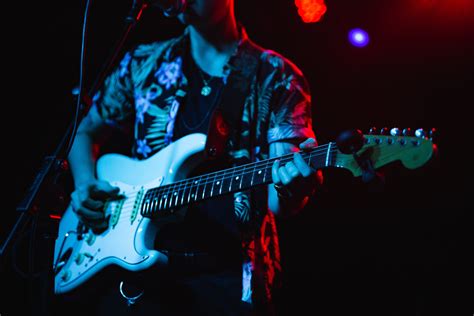 Person Singing While Playing Electric Guitar · Free Stock Photo