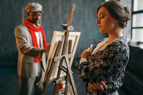 Premium Photo Portrait Painter At The Easel Draws Female Model Male