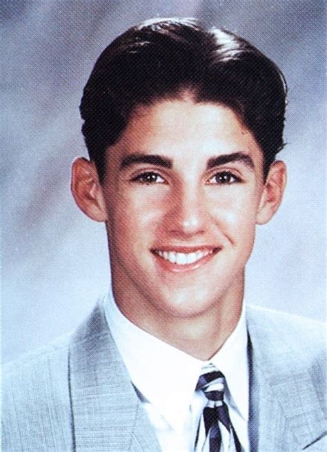 a young man wearing a suit and tie