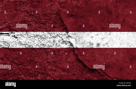 Flag Of Latvia Close Up Painted On A Cracked Wall Concept Of Armed