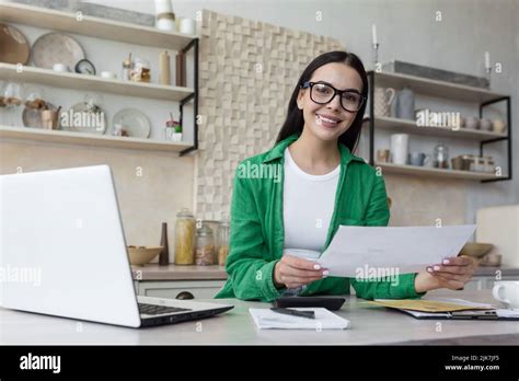 Happy And Successful Business Woman Working At Home In Kitchen Looking