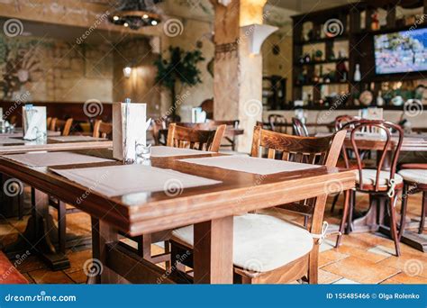 Wooden Brown Tables With Wooden Chair In The Cozy Restraunt Stock Photo