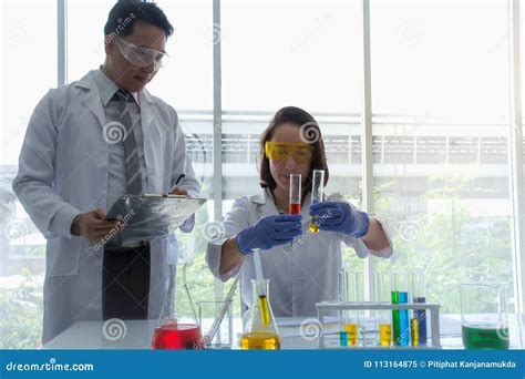 Close Up Of Scientist Chemist Holding Tube With A Red Liquid Chemical