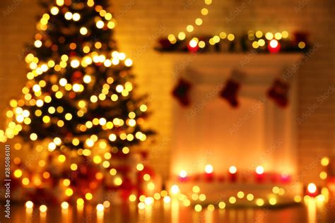 Blurred Background Of Decorated Fireplace Near Christmas Tree Stock