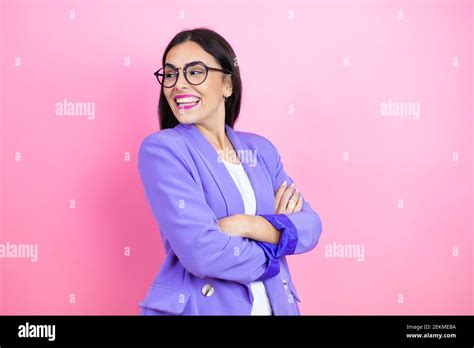 Young Business Woman Wearing Purple Jacket Over Pink Background Looking