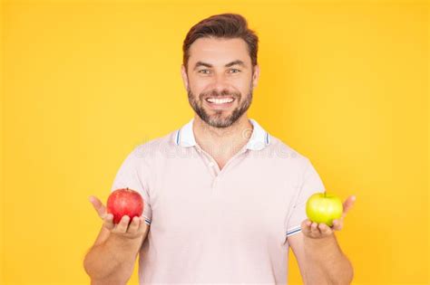 Stomatology Concept Man With Perfect Smile Holding Apple On Studio