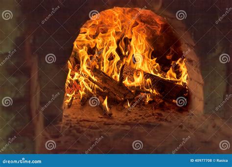 Firewood Burning In Old Brick Furnace Stock Photo