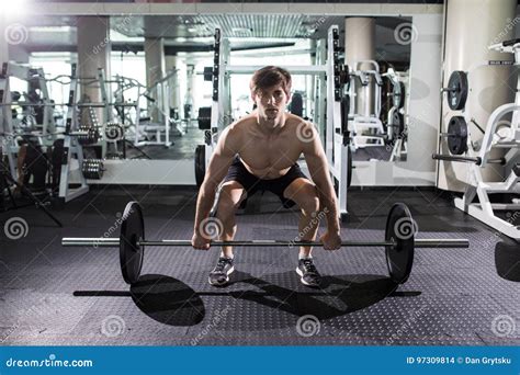 Confident Muscular Man Training Squats With Barbells Over Head Closeup