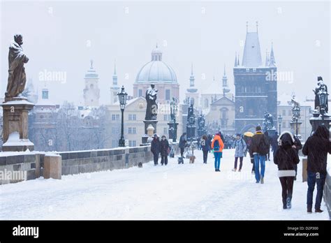 Czech Republic, Prague, Charles Bridge - people walking during snowfall Stock Photo - Alamy