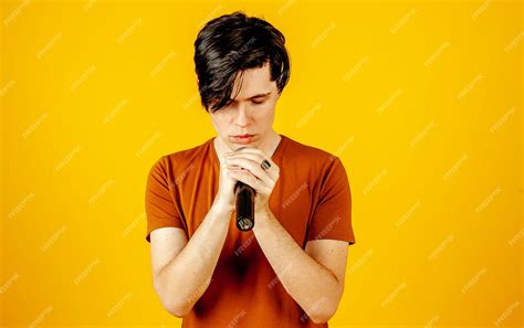 Premium Photo Karaoke Man Singing A Song Into A Microphone On A