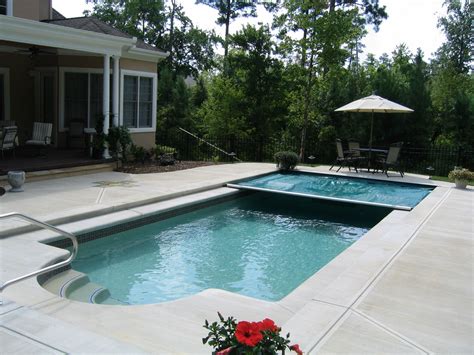 Fiberglass Inground Pool With Pool Cover Partially Unfurled