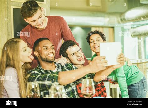 Group Of Cheerful Friends Taking Selfie Photo With Tablet In Wine Bar