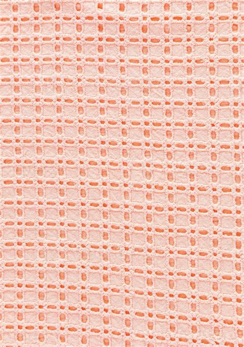 Textile background made of lace cotton fabric in peach color. Industry and Fashion trending ...