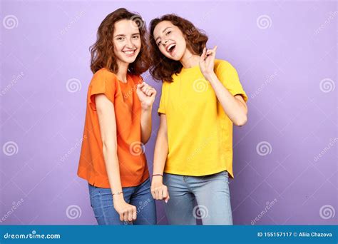 Cheerful Two Sisters Expressing Positive Emotion Celebrating Success