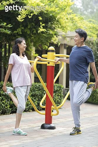 Happy Mature Chinese Couple Exercising In Park A