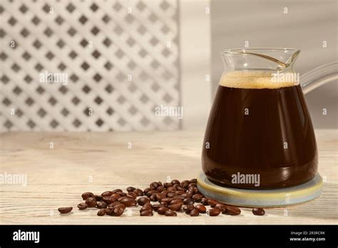Glass Turkish Coffee Pot With Hot Drink And Beans On Wooden Table Space For Text Stock Photo