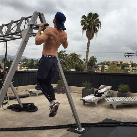 A Man Standing On Top Of A Metal Ladder