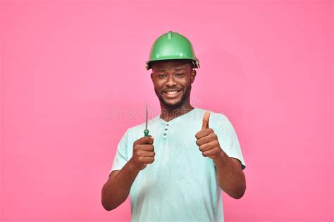 Handsome Excited Young Black Man Wearing A Hard Hat And Holding A