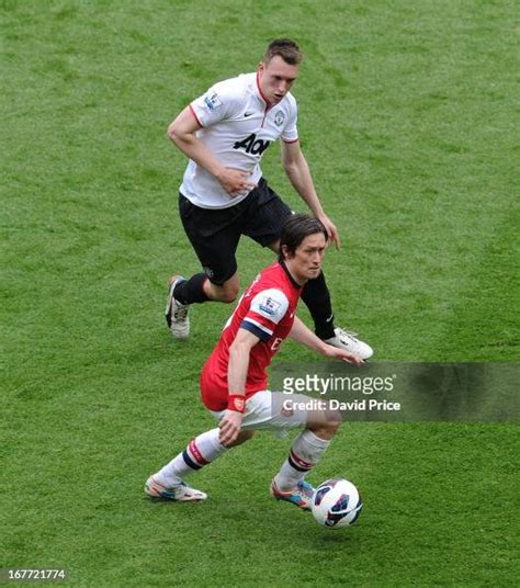 Tomas Rosicky Of Arsenal Under Pressure From Phil Jones Of Man Utd