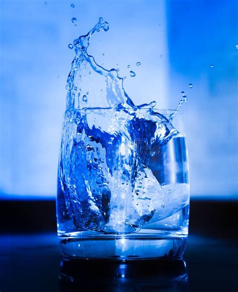 Ice Dropping Into A Glass Of Water Stock Photo Image Of Bubble Shape