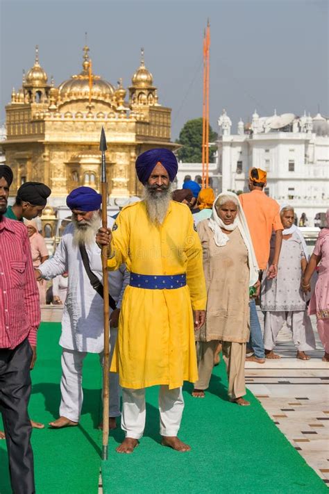 Sikh Man And Indian People Visiting The Golden Temple In Amritsar