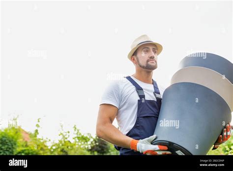 Portrait Of Mature Gardener Carrying Pots In Shop Stock Photo Alamy