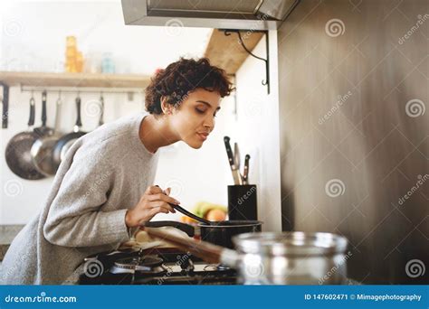 Young Woman Cooking and Smelling Food from Pot Stock Image - Image of ...