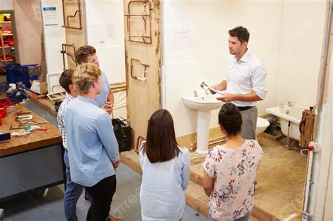 College Students Studying Plumbing Working On Washbasin Background