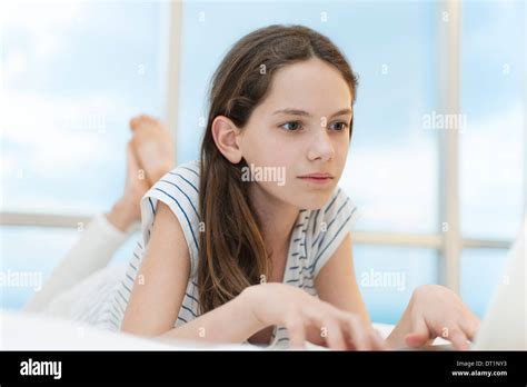 Preteen Girl Lying On Stomach Using Laptop Computer Stock 31578 Hot