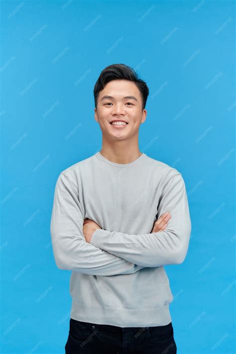 Premium Photo Smiling Handsome Asian Man With Arm Crossed Looking At