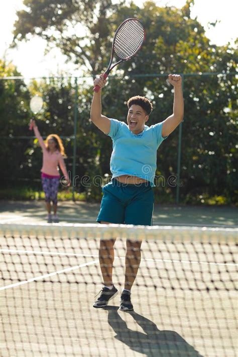 Smiling Biracial Couple Playing Tennis Shaking Hands On Outdoor Tennis