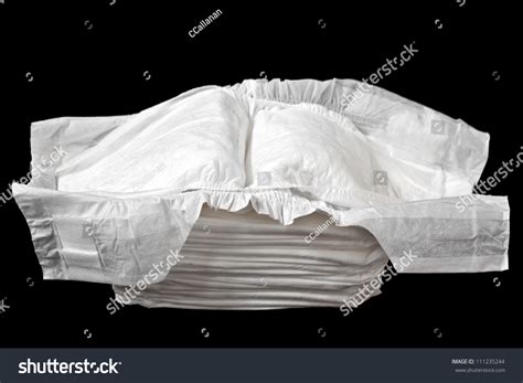 A Stack Of White Disposable Diapers Isolated On A Black Background