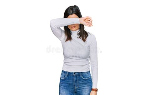 Beautiful Brunette Woman Wearing Casual Clothes Covering Eyes With Arm