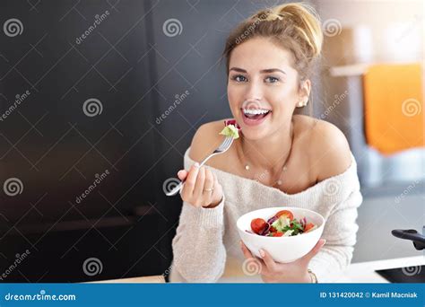 Beautiful Smiling Woman Eating Fresh Organic Vegetarian Salad In Modern