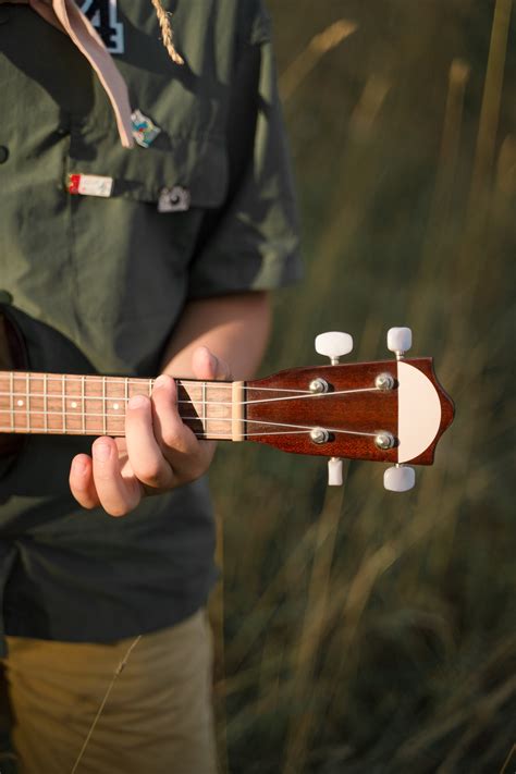 Person Playing Brown Ukelele · Free Stock Photo