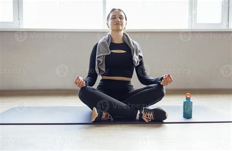 Lotus pose with mudra, working out, woman wearing sportswear 49125185