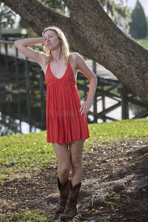 Blonde Woman In Red Dress And Cowboy Boots Stock Image Image Of Lake Tree 370429721