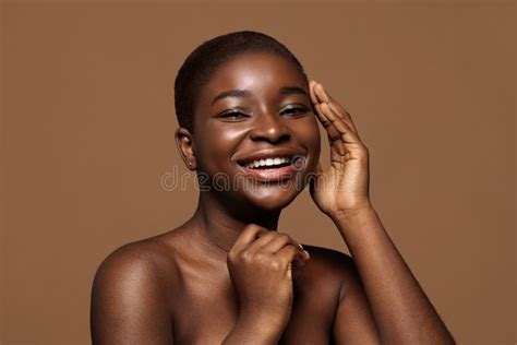 Essential Beauty Portrait Of Nude Attractive American Woman Touching Her Smooth Skin Stock