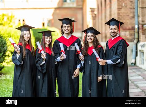 Happy Graduates Five College Graduates Standing In A Row And Smiling