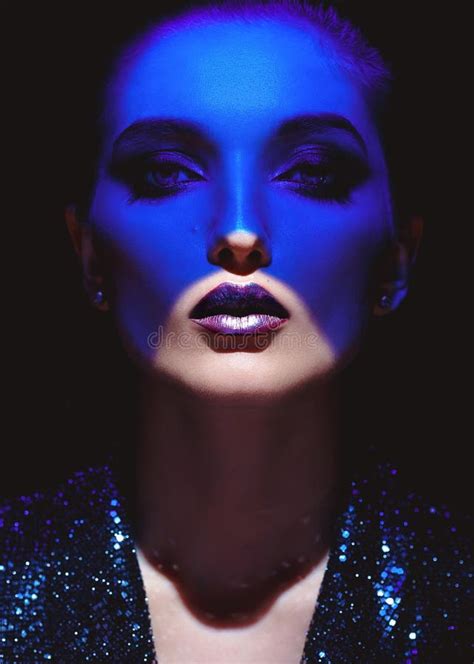 Portrait Of Fashion Girl With Stylish Makeup And Blue Neon Light On Her