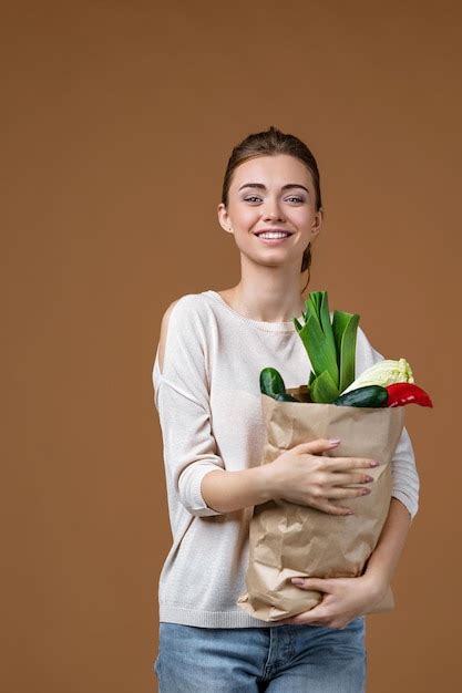 Premium Photo Woman Holding A Shopping Bag Full Of Groceries