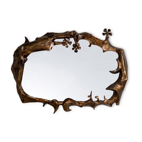 A Mirror That Is Made Out Of Wood And Has Flowers On The Top Of It