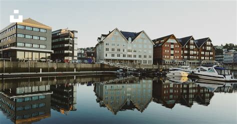 White And Brown Concrete Building Beside Body Of Water During Daytime Photo Free Water Image