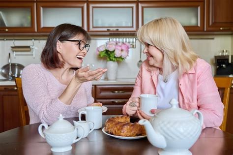 Premium Photo Friends Two Mature Women Drinking Tea With Cupcake In